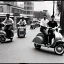 Placeholder: Old 1950s photo of people driving a scooter