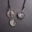 Placeholder: pendant in a form of two conjoined silver coins, watercolor, large strokes, illustration, fantasy