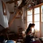 Placeholder: Beautiful female artist painting a self portrait in her attic studio, dramatic light, shadows