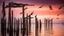 Placeholder: Large birds fly between long, fragile bamboo pillars that support dilapidated cabins in uncertain balance, over a calm sea where small fishing boats work, in an atmosphere of reddish sunset