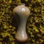 Placeholder: artistic photo of a tiny cracked ceramic vase repaired with gold, kintsugi, garden setting, beautiful landscape photography, beautiful, vines and leaves, delicate, cinematic, high detail, beautiful composition, delicate arrangement, aesthetic, soft lighting, award winning photography, tender