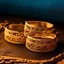 Placeholder: A set of elegant, gold-plated rings adorned with intricate gemstones, reflecting a soft, warm light