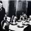 Placeholder: Creepy old photo of giger alien people sitting at dinner with weird children