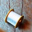 Placeholder: spool of thread on windowsill