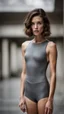 Placeholder: beautiful anorexic secretary, total shot, short shiny grey triathlon swimsuit, short brunette wavy bob hair, blurred concrete background, standing