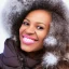 Placeholder: Futuristic portrait of a black woman with realistic facial features, perfect smile, and brown coily hair in winter wonderland