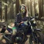 Placeholder: Very attractive woman sitting on a motorcycle. The bike is Yamaha. In the background is a forest. Realistic details. Photorealistic. 4K.