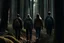 Placeholder: group of people walking in silence out of forest