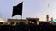 Placeholder: black flag raised at razavi shrine in mashhad echoing prophetic hadith about khorasan,