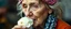 Placeholder: close up portrait of the sweetest soulfull magical old woman with no makeup eating ice cream like a pig