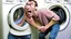 Placeholder: very skinny man upset he is unable to move damaged dryer