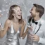 Placeholder: Photograph of a happy couple celebrating with silver party decoration.