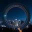 Placeholder: a city scape with skyscapers in a bdarkblue stary sky at background ,with a huge vertiacal ring structure like a lens zoom on midle-city