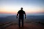 Placeholder: a brawny man with grey hair views sunset from a cliff