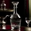Placeholder: Design an antique-style decanter with a long, slender neck and intricate crystal patterns. The decanter should be filled with a bright red liquid, evoking the richness of fine wine. Capture the elegance and luxury of a bygone era in the artwork.