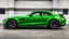 Placeholder: Mercedes-Benz AMG GT63s, green, with four side doors parked in a luxury garage, with the car facing right