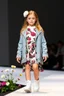 Placeholder: 3 years old german girl with fashion modern clothing in runway with flowers