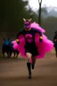 Placeholder: batman adult wearing a bright pink tutu, running away from wild boars.