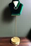 Placeholder: dark green velvet Necklace Mannequin Stand on a luxury table