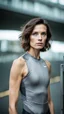 Placeholder: photography of a beautiful anorexic woman, grey satin triathlon top, brunette wavy bob haircut, flat chest, grey satin cycling leggins