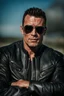 Placeholder: Handsome and muscular 40 year old Biker wearing a leather jacket and dark sunglasses standing with his arms folded