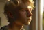 Placeholder: A realistic close up portrait of a cute teen boy with honey brown eyes and golden blond hair, innocent and thoughtful, gazing out a window, a hint of facial hair, wearing sleeveless shirt, inside an empty room with warm sunlight streaming in, detailed, high definition, 4K, 8K, quality render