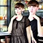 Placeholder: Russian boyish boylike female figure guy short man's haircut men's face boyish features in black girlish lacy cocktail dress earrings in restaurant