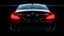 Placeholder: Full view of the rear view of a black Mercedes-Benz CLS 550 with bright neon lights on a black background