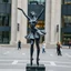 Placeholder: photo of a statue of ballerina made of black marbel in a modern city center