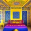 Placeholder: The room is filled with the vibrant colors and patterns characteristic of Kutchi design. The walls are painted in a sunny yellow hue, adorned with intricate white motifs inspired by traditional Kutchi embroidery. The ceiling is a rich cobalt blue, with delicate silver filigree patterns swirling across its surface. In the center of the room, a low-lying divan covered in a brightly-colored Kutchi rug provides a cozy spot to sit and relax. A series of colorful cushions in a variety of patterns and