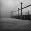 Placeholder: An empty carpark on a misty day. Telegraph poles and wires. Muted tones. Tilted horizon. With blotches, blurry areas and lens noise and grain. Hyper realistic Photo 4k