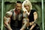 Placeholder: Jason David Frank Very muscular man with short hair and tribal tattoos piercings carrying very pretty thin blonde girl bridal style