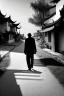 Placeholder: Black & white man walks on road's chinese village with playing light and shadow as ho fan style