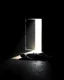 Placeholder: In a dark room, light streams in through an open door symbolizing new possibilities, hope, and overcoming problems.a man is laying down dead , a man is standing looking at him