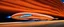 Placeholder: award winning car and driver photograph of a futuristic station wagon dirigible hybrid designed by only one vehicle per image painted metallic orange traveling at a high rate of speed, jet intake off of front center of vehicle and jet exhaust out the rear with bright blue flame, bilaterally symetrical, more a high speed road vehicle