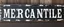 Placeholder: fill composition with large and wide historical hand painted old western sign that reads: "MERCANTILE" white on black with inset white stripe boarder aged paint on wood sanserif