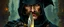 Placeholder: oil paint and airbrush, upper body portrait of clever crow vintage mustache cloaked assassin thief quickling juggler man with Damascus steel sacrificial dagger in then elven magical green city of Forgotten Realms, myth drannor