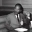 Placeholder: Martin Luther King Jr. eating pizza at a Denny's restaurant