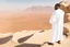 Placeholder: african man wearing white thobe. standing on high mountain looking out to the desert