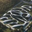 Placeholder: Complex of ten oval cabins, Zaha Hadid style, aerial view, ultra quality, hyper-detailed, digital art, 8k 3D, trees, parking lots, people