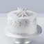 Placeholder: A picture of a simple white cake with silver decoration