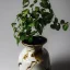 Placeholder: photo of a cracked ceramic vase repaired with gold, kintsugi, beautiful, vines and leaves, rosebuds, delicate, cinematic, high detail, beautiful composition, delicate arrangement, aesthetic, soft lighting, award winning photography, tender