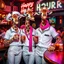 Placeholder: very Gay Giraffes sailors with white shirts, tight pants, happy tail and berets standing in a bar drinking drinks with umbrellas, pride, makeup, smoking cigaretts, smiling, sparkling eyes, very happy, after dark, pink scarf, happy hour drinks neon signs, necking, happy cock hour, pride, pride and pride