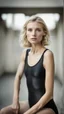 Placeholder: beautiful anorexic woman, total shot, short shiny black triathlon swimsuit, short blond wavy bob hair, blurred concrete background