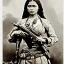 Placeholder: sepia artwork of beautiful female mexican outlaw wearing holster with two guns on waist and bandolier on chest, long black wavy hair, gorgeous, stunning face, 8k, high-quality, ultra-fine detail, 1800s wild west, detailed matte painting, brian froud, howard lyon, selina french, anna dittmann, annie stokes, lisa parker, greg rutowski, alphonse mucha