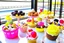 Placeholder: desserts in sunshine: ice cream sundaes, cakes, chocolates, macarons, floss candy, cookies, biscuits