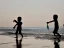 Placeholder: children playing on the Indian beach capture them against the sun and make an art silhouette, hyper details, real sharp, 8k, well detailed, well shaped