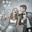 Placeholder: Photograph of a happy couple celebrating with silver party decoration.