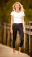 Placeholder: anorexic beautiful woman, age 30, total shot, black capri leggins, white t-shirt, blonde surfer hair, blurred beach background