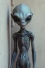 Placeholder: a beautiful gray alien body details standing by a wall front view scared
